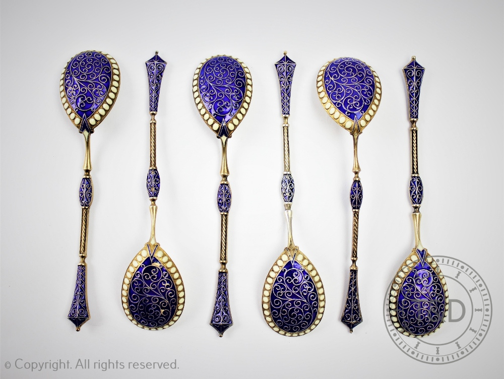 A set of six continental gilt white metal and enamel spoons,