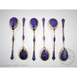 A set of six continental gilt white metal and enamel spoons,
