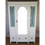 An Adam style painted wood and gesso break front wardrobe, with glazed door above three drawers,