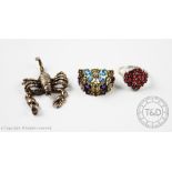 A multi gems set dress ring designed as multiple flower heads to the bifurcated shoulders and plain