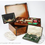 A Victorian walnut work box containing a collection of thimbles,