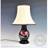 A Moorcroft Anemone pattern lamp, on fitted wood base, with shade,