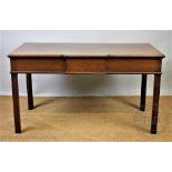 An Edwardian mahogany break front serving table, on moulded and chamfered legs,