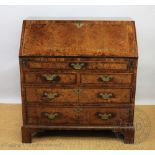 A George III and later cross banded walnut bureau,