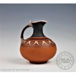 A terracotta ewer in the manner of Dr Christopher Dresser for Watcombe pottery,