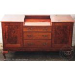A 1920's mahogany sideboard, with an arrangement of three drawers and two panelled cupboard doors,