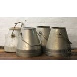 Four aluminium milk churns,