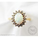 An opal and diamond oval cluster ring,