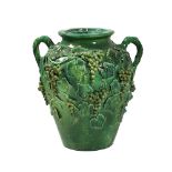 VASO in ceramica smaltata nei toni del verde con decori di uva e tralci di vite, XX secolo Misure: h