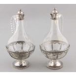 Two carafes with silver, 915/000, convex carafes with round silver base with holder decorated with