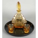 Four-piece Art Deco pressed glass liqueur set with yellow colored glasses, decanter and black