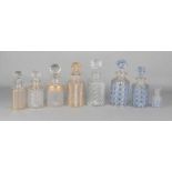 Eight old / antique crystals / glass cork decanters. 20th century. One set of three gold / blue.