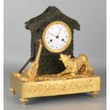 Antique French fire gilt directoire pendule with wolf, stringed instrument and bronzed bronze house.