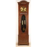 Antique German oak clock with brass dial, weights and pendulum. Clock has half-hour movement on five
