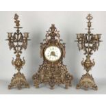 Antique French bronze clock set with five-armed candle candlesticks. Clock has eight-day clock,