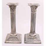 Two silver candlesticks, 925/000, English. Two column candlesticks on square feet with pearl edge, a