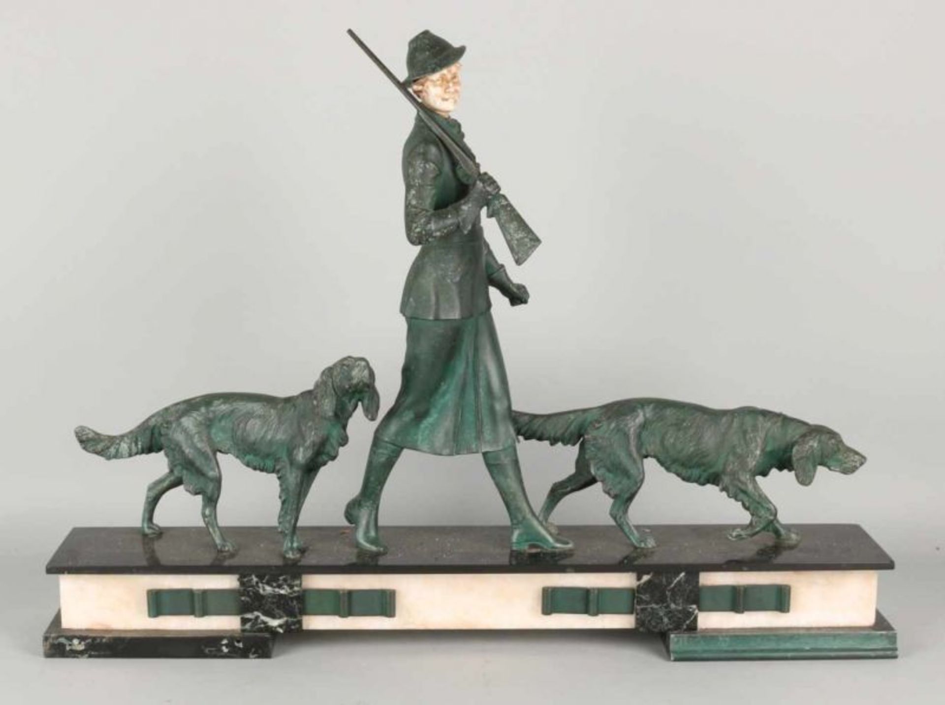 Large antique Art Deco image. Female hunter with hunting dogs on marble basement. Circa: 1930.