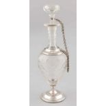 Carafe with grinding on silver base with fillet edge and a silver collar with chain at the stop.