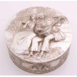 Round silver box, 835/000, with a hinged lid with a representation of a pair on a bench The edge