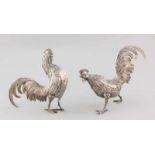 Two silver ruffs, 925/000, Spanish. 20x14cm and 16x16cm. Both cocks lack a piece of a leg, otherwise