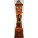 Walnut freestanding freeman with carving. 20th century. Clock has wooden dial with brass figures,