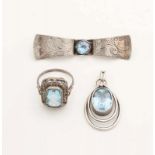 Three silver jewelry with light blue stones, with a brooch, a ring and a pendant. Various