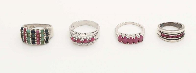 Four silver rings, 925/000, a wide ring with rows of ruby, emerald and sapphire, ø 63, a wide ring