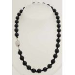 Necklace made of gauze, faceted ø 9.5 mm, with small beads in between attached to a silver clasp,