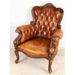 Baroque-style chair with sofa back and arms. Chair has various carving and is equipped with cognac-