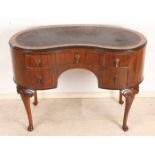 Antique kidney-shaped walnut writing desk with leather writing top. Quality furniture. Circa 1900.