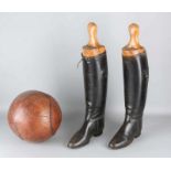 A pair of antique leather riding boots and leather medicine ball. Circa 1900. Size: 25 - 60 cm. In