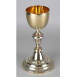 Silver chalice, 833/000, on large round foot and a round gilt chalice. The edge of the foot is