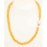 Necklace of faceted citrine beads, 8 mm, attached to a smooth oval yellow gold clasp. length 43