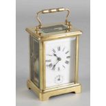 Old brass travel alarm clock with seconds indication and cut glass. 20th century. Percussion on