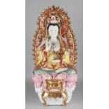 Very large porcelain buddha statue with gilding. Handpainted, sitting on lotus flower. 20th century.