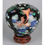 Old Chinese porcelain Family Noir ball vase with fire-breathing Foo dogs + soil brand. 20th century.