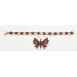 Silver plated bracelet and brooch, 900/000, set with garnet. A brooch in the shape of a butterfly,