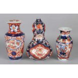 Three times 19th century Imari porcelain, floral + gold decor. Consisting of: Rare cusp vase, two