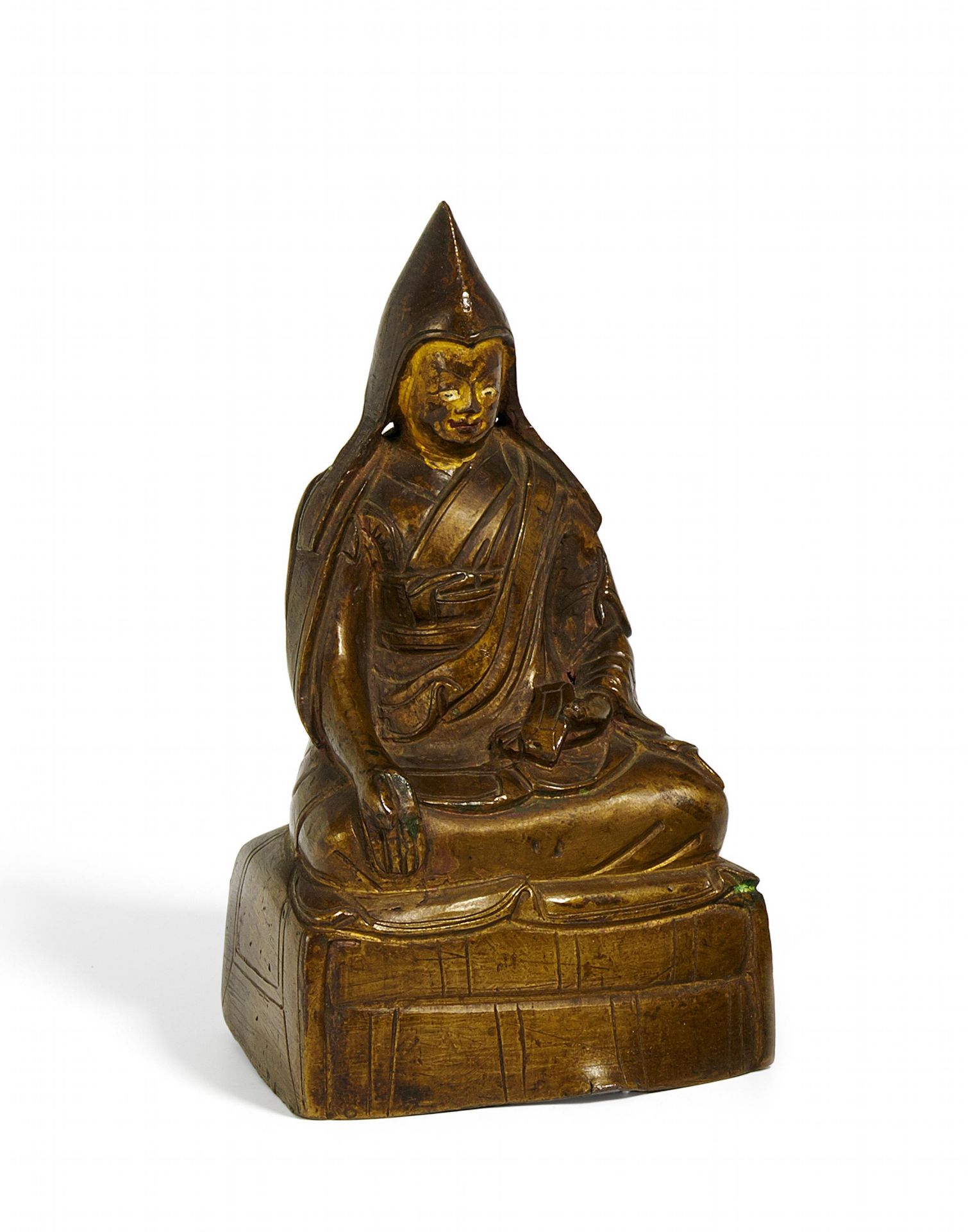 LAMA MIT PANDITA-MÜTZE. Tibet. 17. Jh. Kupferbronze mit Resten von Kaltgoldbemalung. Sitzend auf