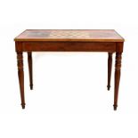 A mahogany games table with reversible top, one side with inlay checkers board, the interior with