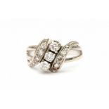 A white gold cross over ring. Set with single and brilliant cut diamonds, total ca. 0.42 ct,