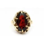 A yellow gold ring. Set with a garnet in leaf shaped mount. Ringmaat 16,5 29.00 % buyer's premium