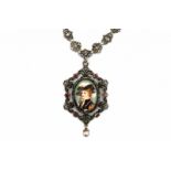 A silver necklace with porcelain portrait medallion. Set with rubies in gold and a natural grey