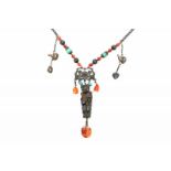 A traditional necklace with ornaments in silver, carnelian and turquoise. With a pendant shaped