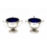 A pair of Sterling silver salt cellars. With blue glass liners. Hallmarked Sheffield. Dated 1910-