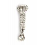 A white gold buckle shaped brooch. Set with one brilliant and 29 single cut diamonds, total ca. 0.