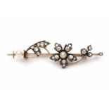 A rose gold with silver brooch with flowers. Set with old and rose cut diamonds and two cultivated