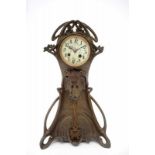 C. Bonnefond A metal table clock with bronze coloured metal swing, decorated with floral pattern