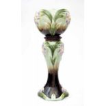 Jugendstil A moulded ceramic flowerpot on pedestal, both decorated with stylized flowers, circa