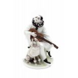 Rudolf Marcuse (1878-1929) A porcelain figure depicting a guitar playing Pierrot with a poodle,